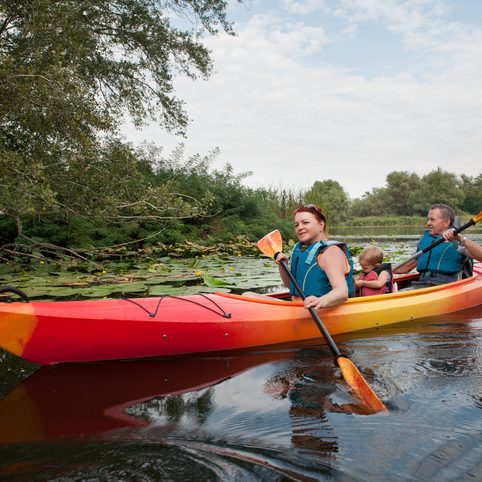 Family in a kayak on a water walk